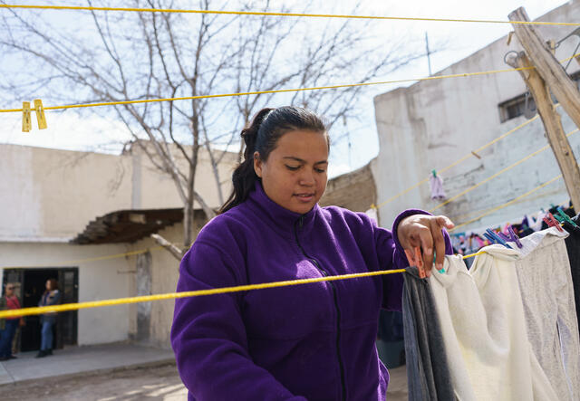 Natalia hangs laundry up