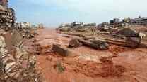 People look at the damage caused by freak floods in Derna, eastern Libya, on September 11, 2023. 